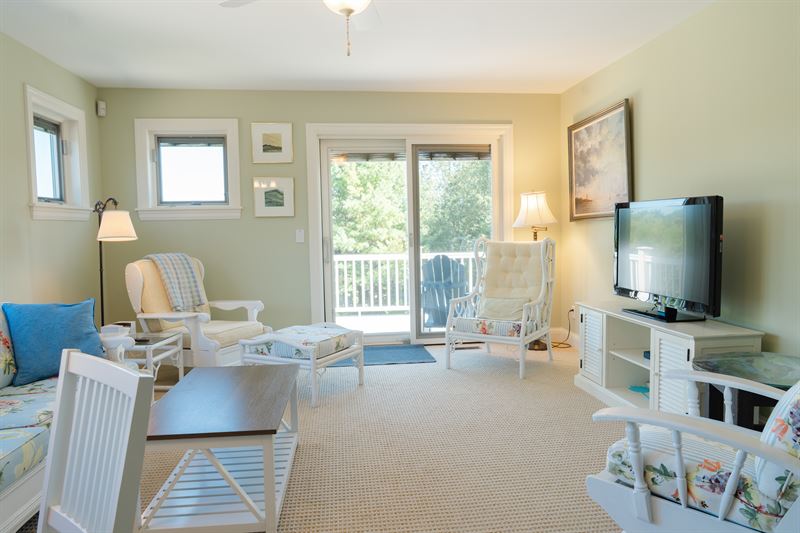 East suite living room with balcony access